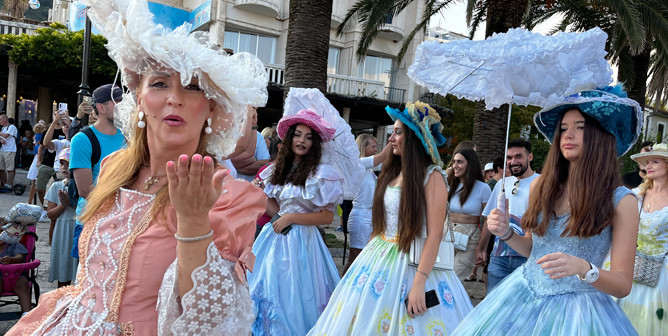 and beautiful ladies walk accompanied by an orchestra