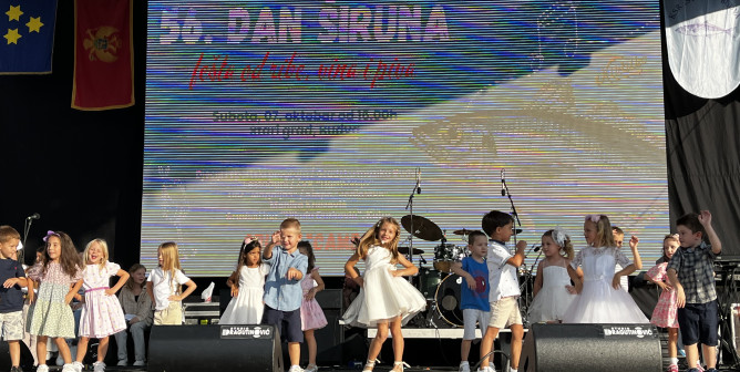 Bright dance on stage near the old town in Budva