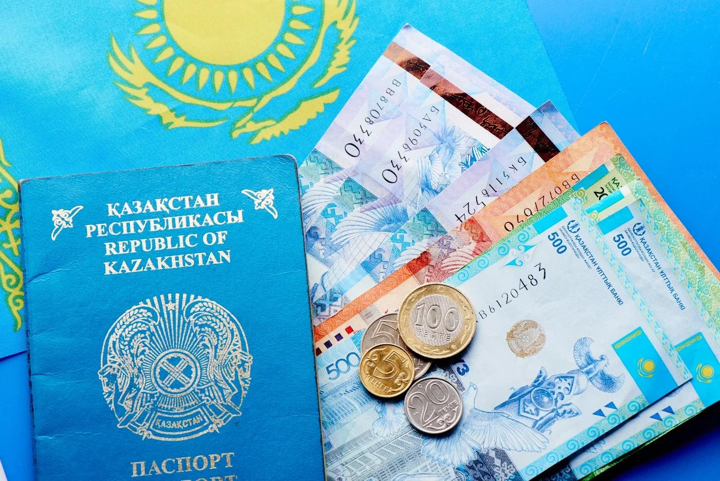Казахстанский паспорт и деньги на флаге Казахстане